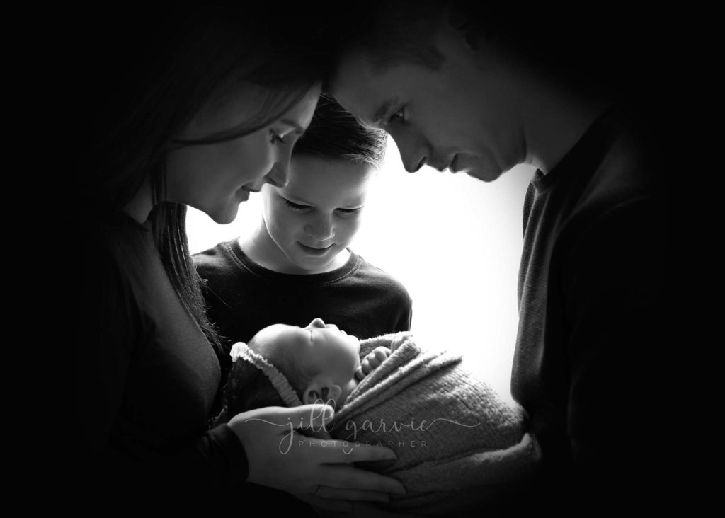 Photograph of Newborn baby girl with Family taken at Jill Garvie Photography studio in Edinburgh.