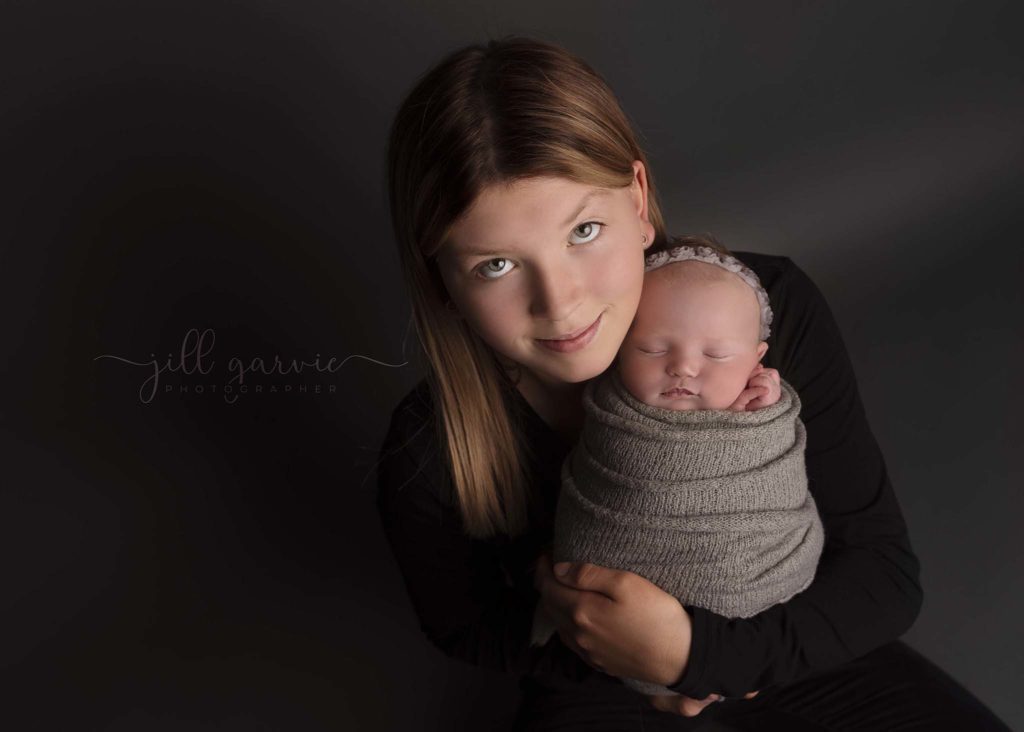 Photograph of Newborn baby girl with sister taken at Jill Garvie Photography studio in Edinburgh.